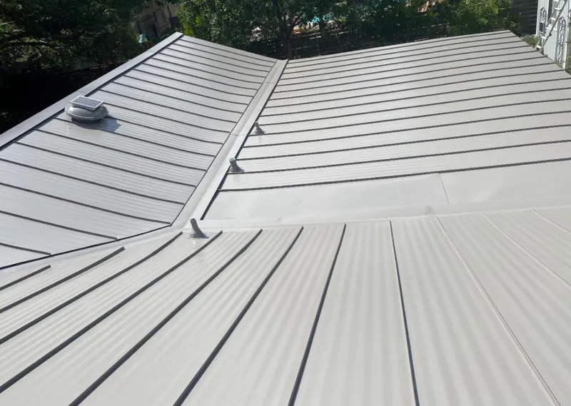 Solar attic fan installed on a metal roof for Roof Ventilation in Abbeville